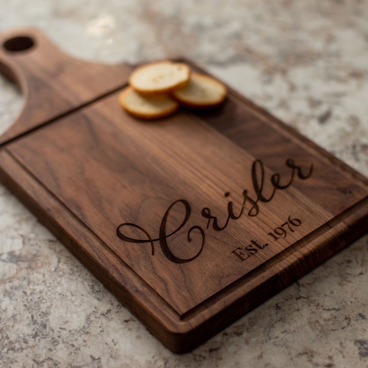 http://www.atompromotions.com/cdn/shop/products/personalized-laser-engraved-walnut-paddle-cutting-boards-680086.jpg?v=1684534166